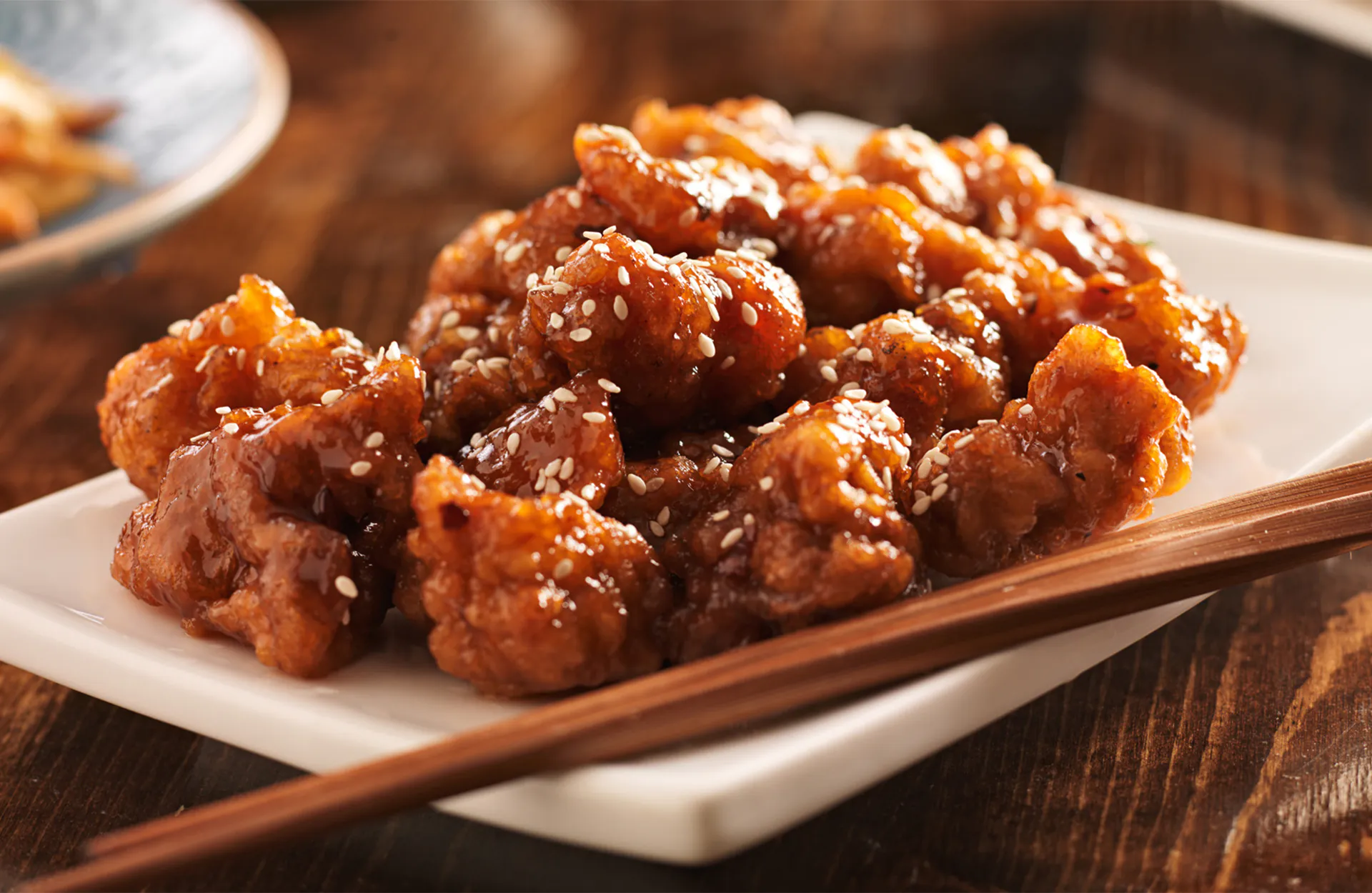 Chinese Sesame Chicken with Chopsticks at Happy Fortune Chinese Restaurant, Chinese Restaurant in Staten Island